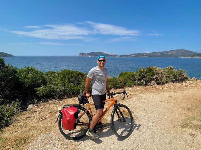 The author cycling along Porto Conte. In the background Capo Caccia